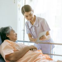 nurse Inform health examination results to encourage senior elderly woman patients in the hospital- medical senior concept